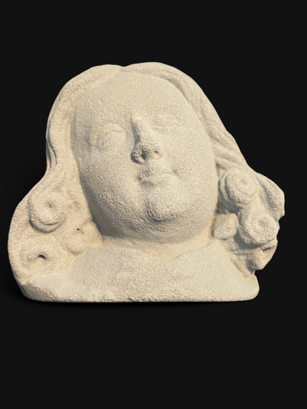 Stone sculpture of an angel's head